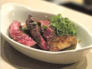 steak cut up and potato in dish
